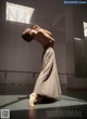 A woman in a long dress standing in a room.